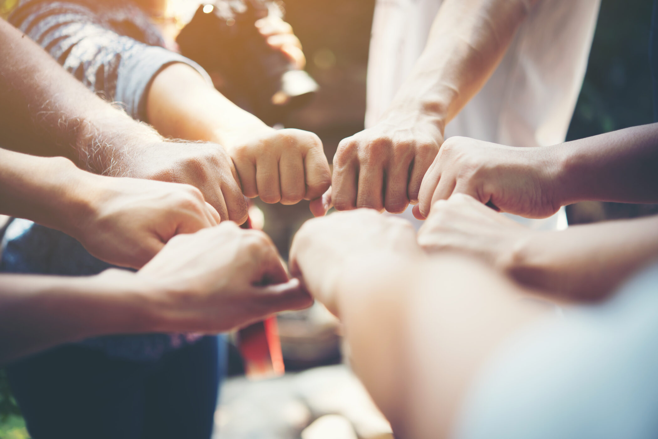 people putting their hands in a circle